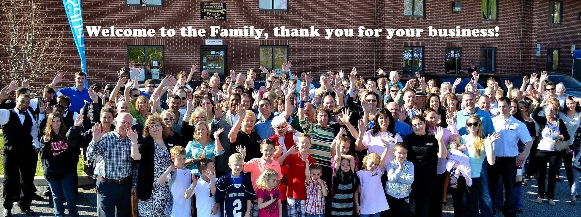 A large crowd of customers and neighbors waving in front of the Family Auto shop